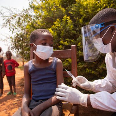 Open air vaccination session in an african village during corona virus pandemic.
