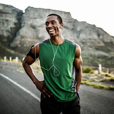 African athlete smiling positively after a good training session outdoors